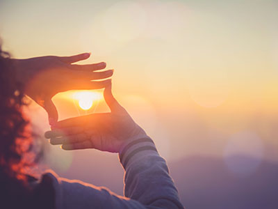 woman looking through hands 400x300 1